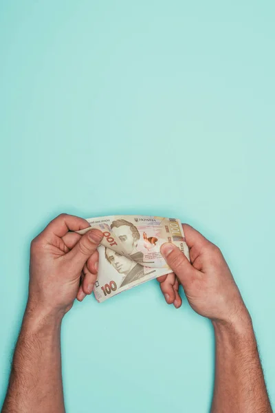 Cropped shot of man counting money isolated on turquoise — Stock Photo