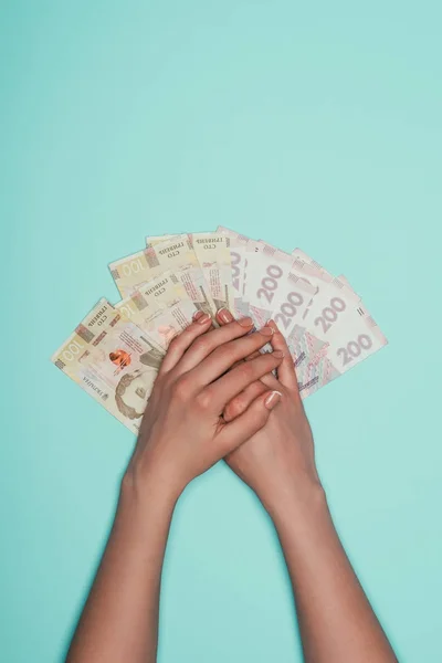 Cropped shot of woman with bunch of cash isolated on turquoise — Stock Photo