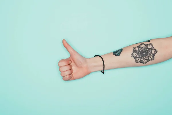 Cropped shot of woman showing thumb up isolated on turquoise — Stock Photo