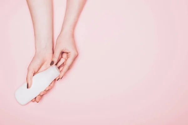 Cropped shot of with bottle of lotion isolated on pink — Stock Photo