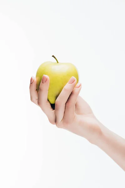 Cropped shot of woman holding fresh green apple isolated on white — Stock Photo