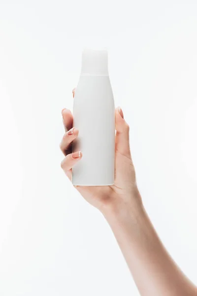 Cropped shot of woman holding blank bottle of lotion isolated on white — Stock Photo