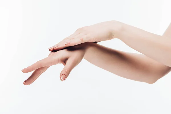 Tiro cortado de mulher aplicando creme cosmético em mãos isoladas em branco — Fotografia de Stock