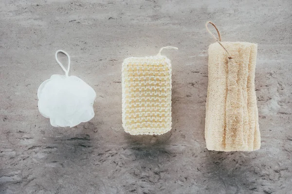 Top view of bath sponges and loofah on marble surface — Stock Photo