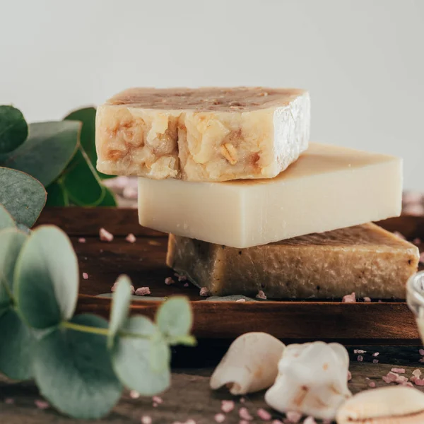 Close up of homemade soap and salt for spa on wooden board — Stock Photo