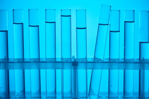 Tubos de vidrio en soporte para análisis químicos en azul - foto de stock