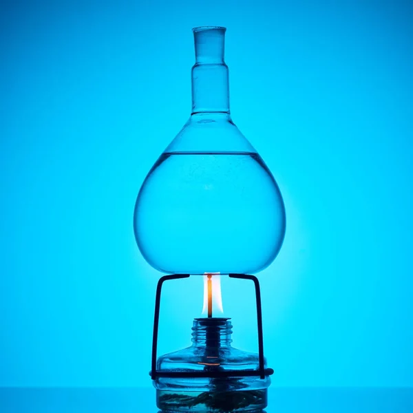 Warming up substance for chemical analysis on blue — Stock Photo