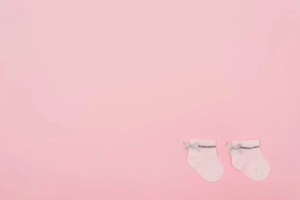 Top view of pink baby socks isolated on pink — Stock Photo