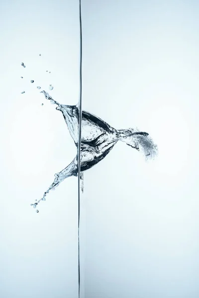 Ice cube in water with splash and drops, isolated on white — Stock Photo