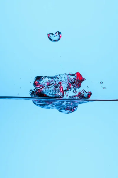 Bubbles in clear water, isolated on blue — Stock Photo