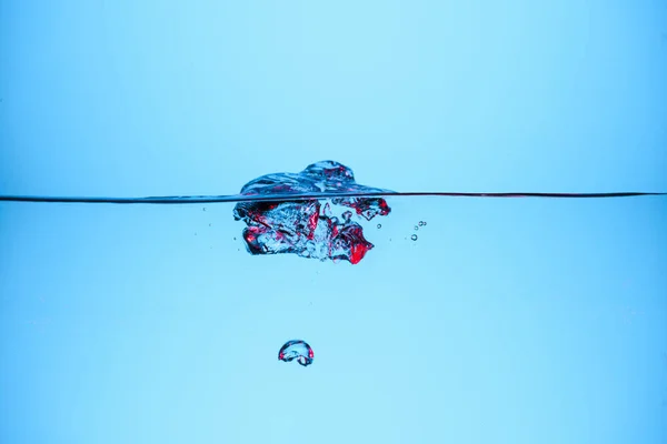 Bubbles in clear water, isolated on blue — Stock Photo