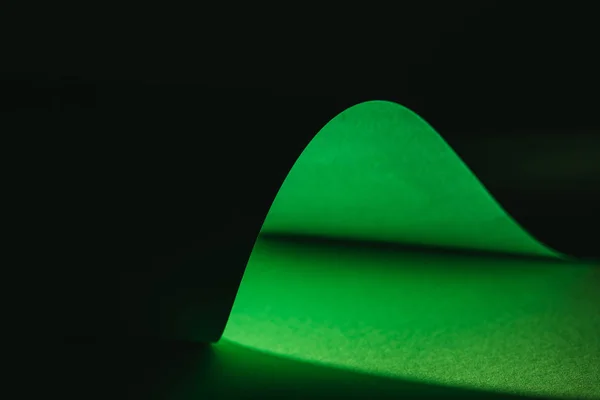Зеленая деформирующая бумага для украшения на черном — стоковое фото