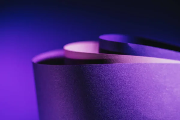 Close up view of arcs of purple and pink paper on purple — Stock Photo