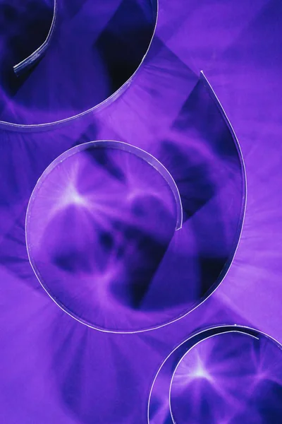 Top view of paper shining spirals on purple — Stock Photo