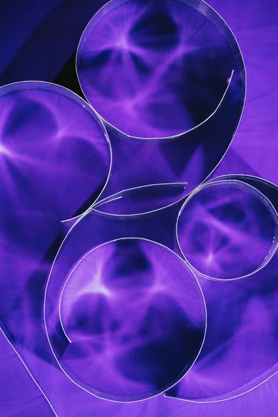 Top view of paper spirals on purple — Stock Photo