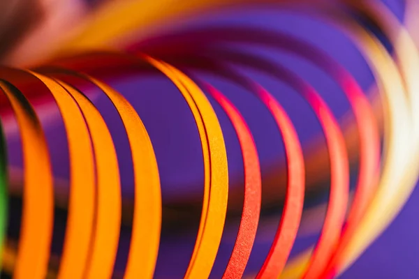 Close up of yellow and red quilling paper curves on purple — Stock Photo