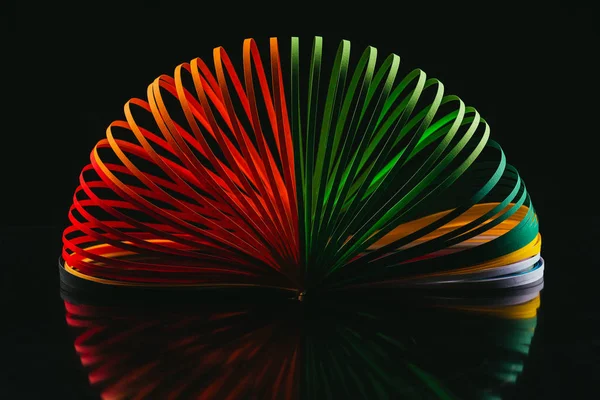 Colored quilling paper curves on black — Stock Photo