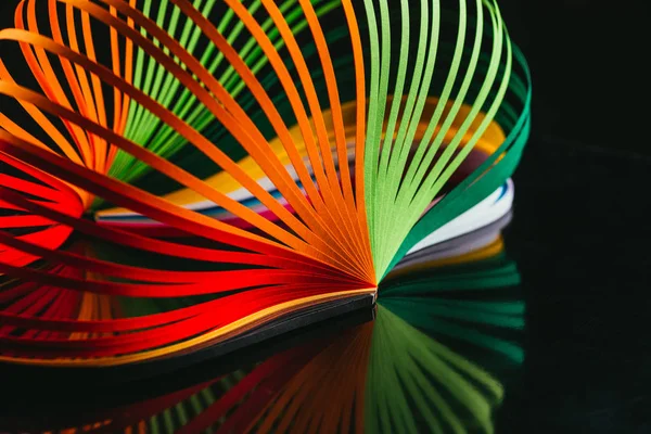 Colored quilling paper curves on black — Stock Photo