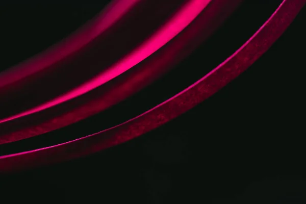 Close up view of crimson quilling striped paper on black — Stock Photo