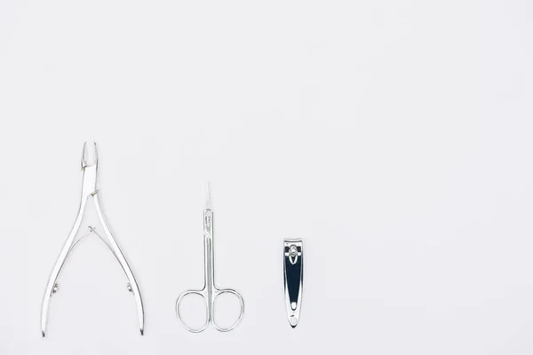 Top view of nail nippers and scissors isolated on white — Stock Photo