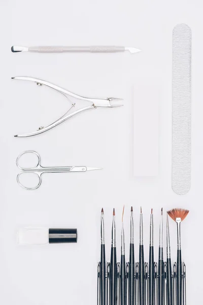 Top view of rows of manicure tools isolated on white — Stock Photo