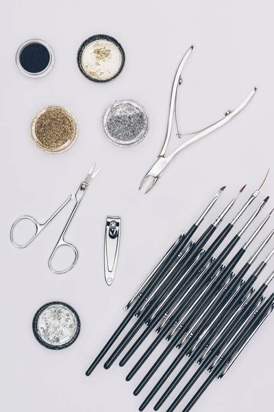 Top view of glitter and manicure tools isolated on white — Stock Photo