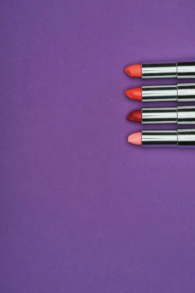 Top view of red and pink lipsticks isolated on purple — Stock Photo