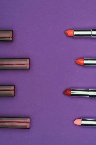 Top view of colored lipsticks isolated on purple — Stock Photo