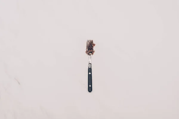 Top view of fork with cake pieces isolated on grey — Stock Photo