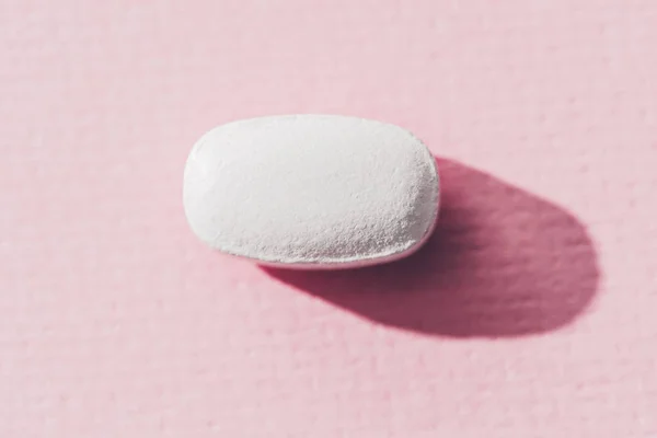 Close up view of medicine on pink surface — Stock Photo