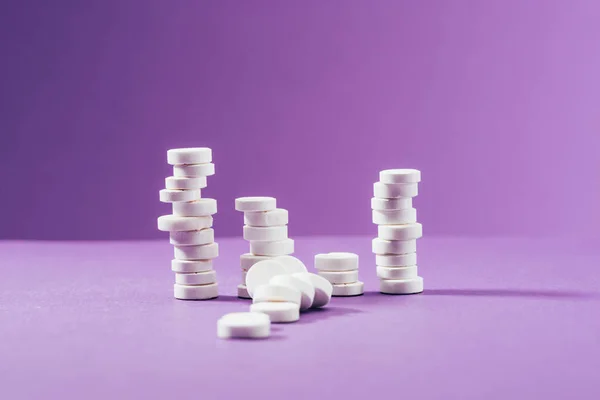 Close up view of arranged pills on purple background — Stock Photo