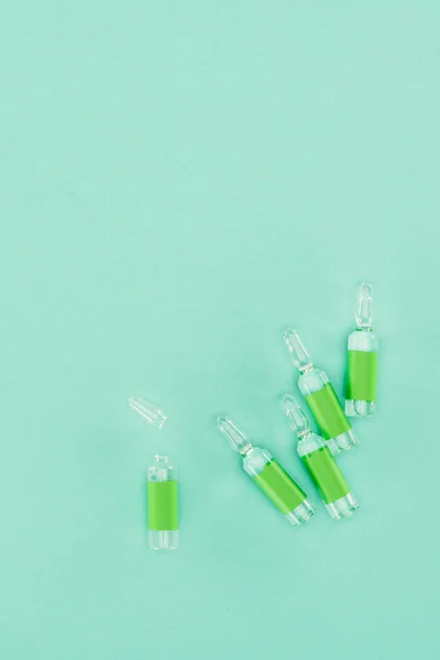 Top view of arranged ampules isolated on green — Stock Photo