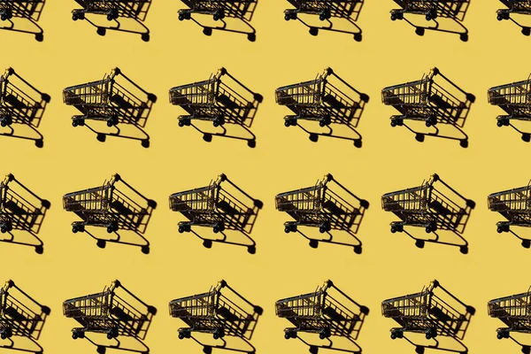 Set of shopping carts with shadows on yellow — Stock Photo