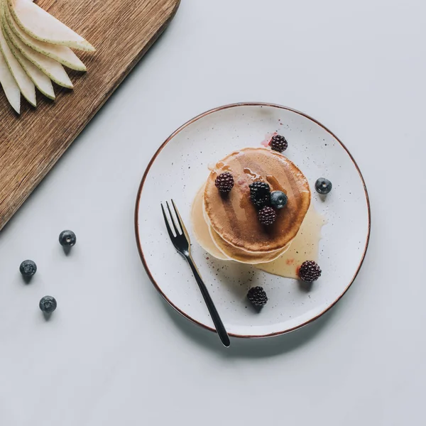 Top view of tasty healthy pancakes with berries on grey — Stock Photo