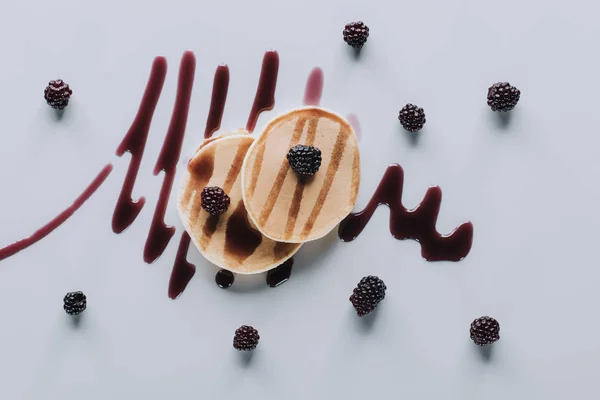 Top view of delicious pancakes with fresh blackberries and jam on grey — Stock Photo