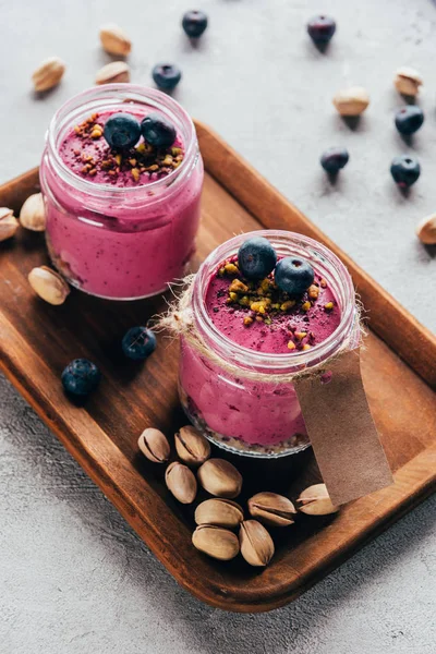 Delicious healthy pink smoothie with nuts and berries — Stock Photo