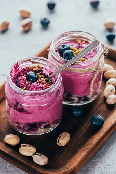 Close-up view of delicious healthy pink smoothie with nuts — Stock Photo