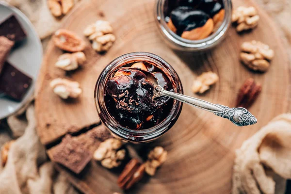 Top view of sweet c chocolate dessert in glass jar with spoon — Stock Photo