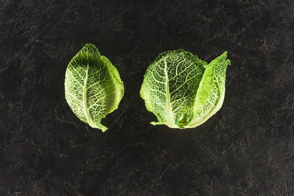 Top view of fresh healthy green savoy cabbage on black — Stock Photo