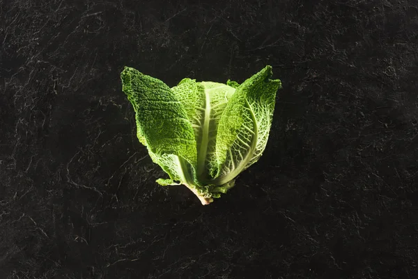 Top view of fresh healthy savoy cabbage on black — Stock Photo