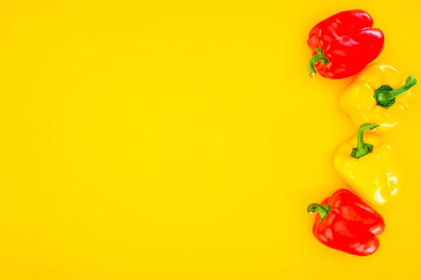 Top view of fresh raw organic peppers isolated on yellow — Stock Photo