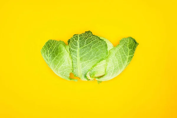 Top view of fresh healthy savoy cabbage isolated on yellow — Stock Photo