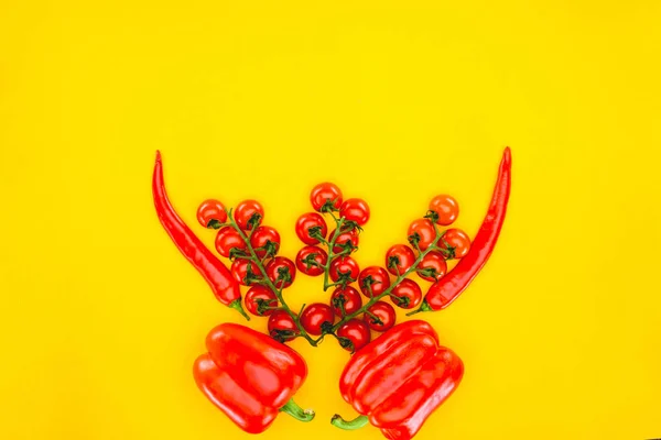 Вид сверху на свежий красный перец и помидоры черри, изолированные на желтый — стоковое фото
