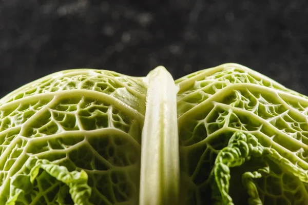 Macro view of fresh healthy savoy cabbage on black — Stock Photo