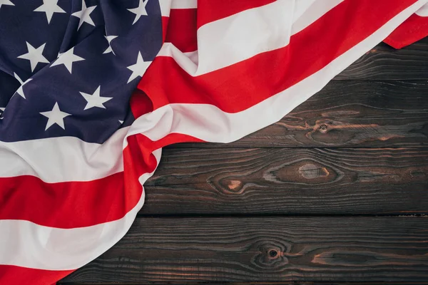 Top view of folded american flag on dark wooden tabletop, presidents day concept — Stock Photo