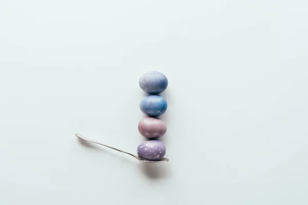 Top view of four painted easter eggs on spoon isolated on white — Stock Photo