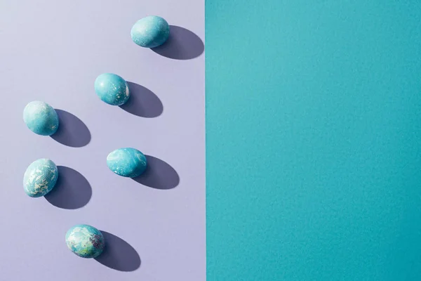 Top view of traditional shabby easter eggs, on purple with copy space — Stock Photo