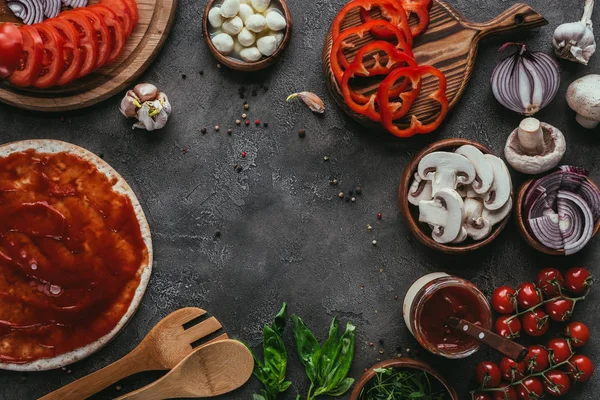 Top view of various pizza ingredients on concrete table — Stock Photo