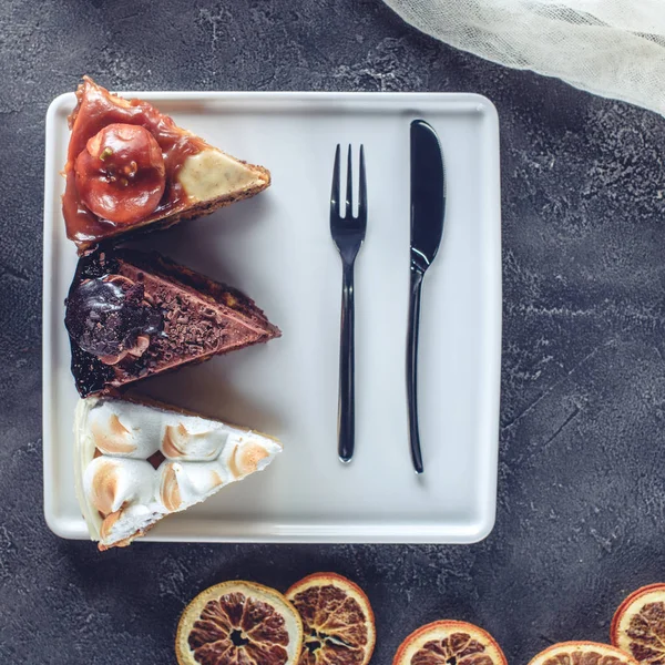 Top view of three pieces of different cakes on plate — Stock Photo