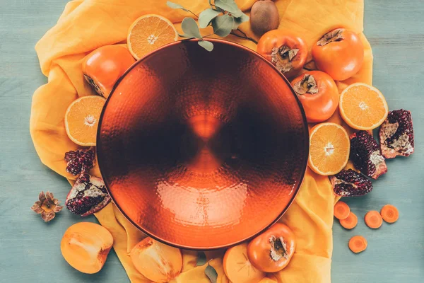 Top view of big red plate between fruits — Stock Photo